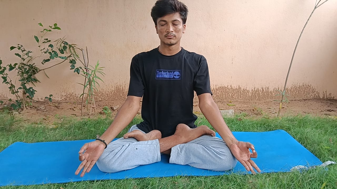 Instructor Chaithanya meditating in lotus pose at sunrise